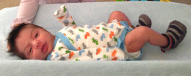 Baby laying down on back
